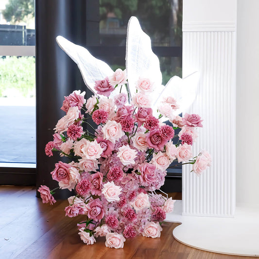 white led butterfly floating on small mixed pink and lilac flower arrangement