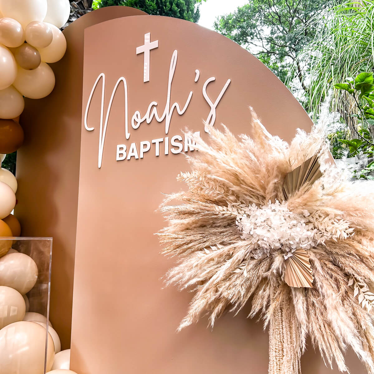 white acrylic lettering stuck on beige backdrop above boho flower arrangement