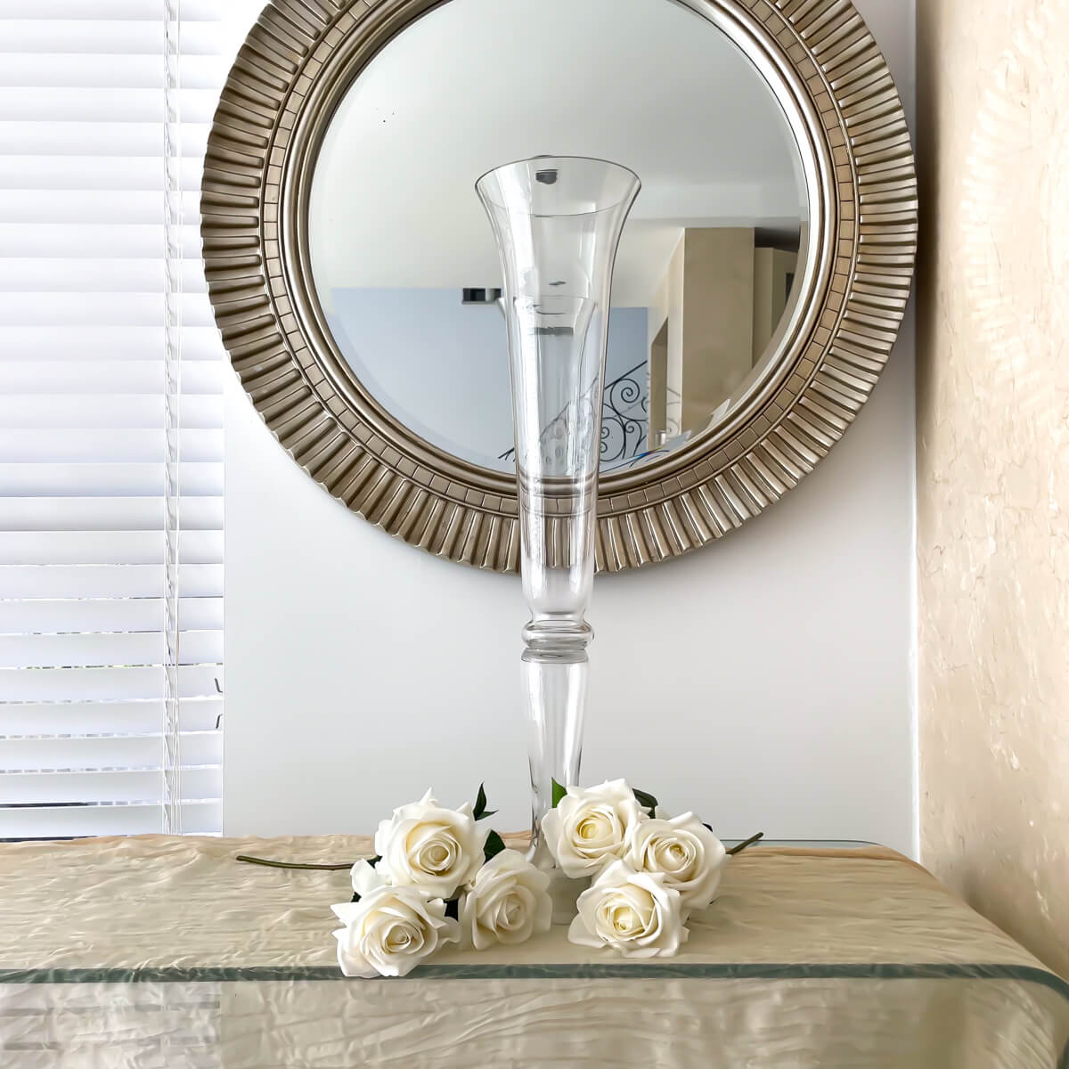 tall wedding glass vase placed on glass table with white roses