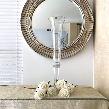 tall wedding glass vase placed on glass table with white roses