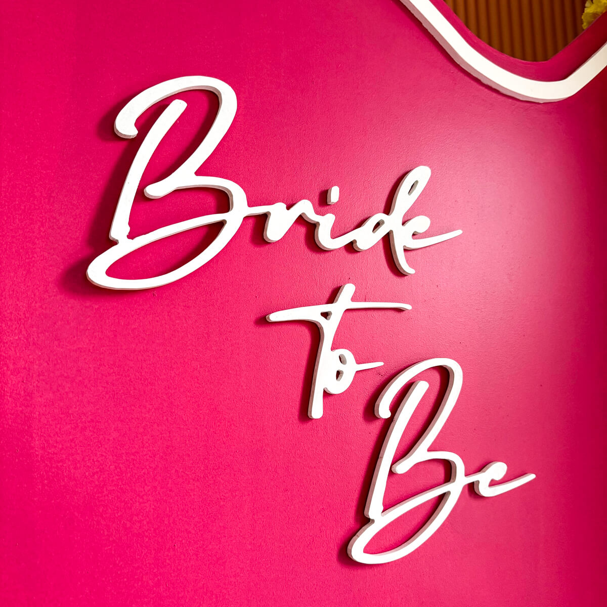 Close up of bride to be decal on hot pink backdrop