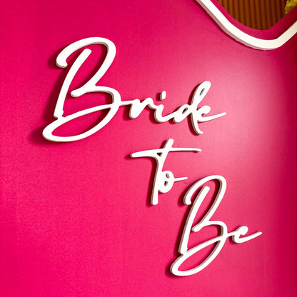 Close up of bride to be decal on hot pink backdrop