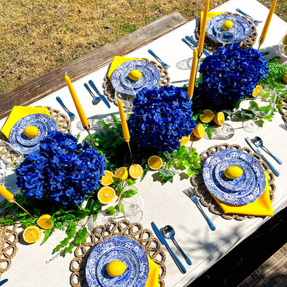 top view of positano table styling featuring flowers, candles and lemons