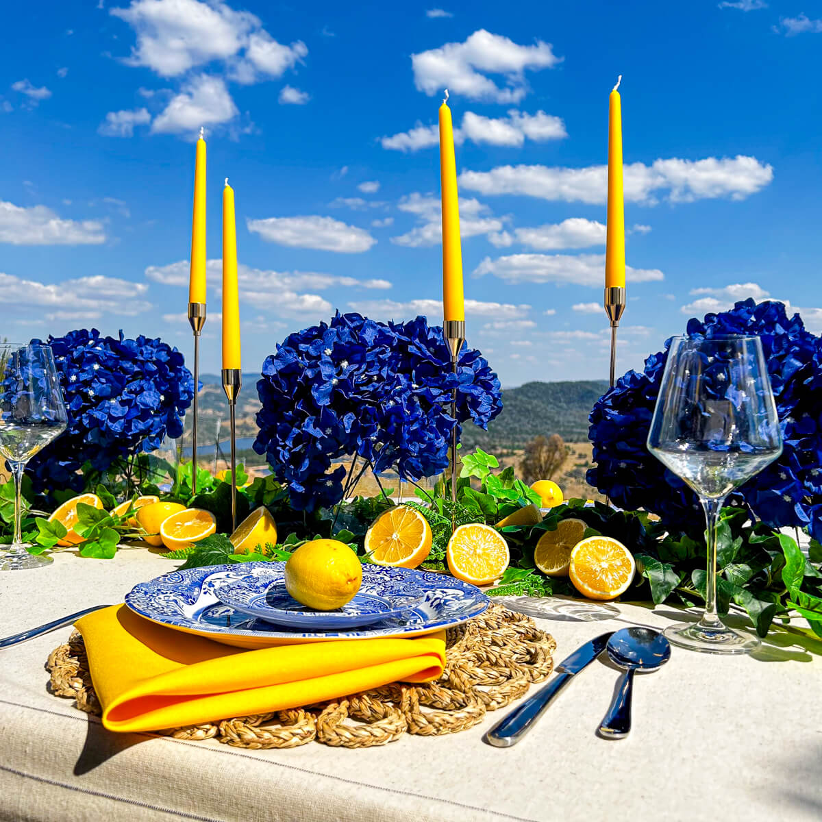 blue and yellow positano table styling with lemons and blue flowers