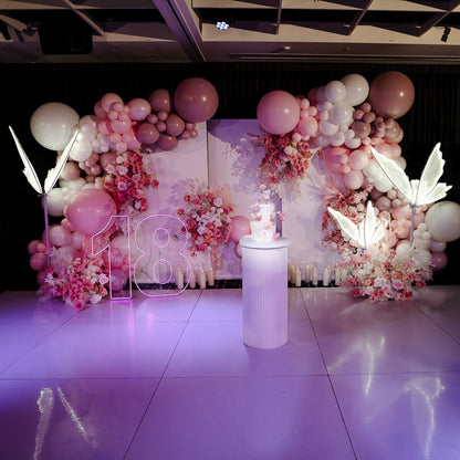 18th birthday backdrop with balloon garlands, flowers and led butterflies