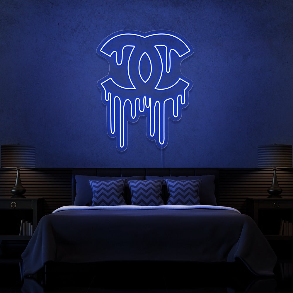 blue dripping chanel neon sign hanging on bedroom wall