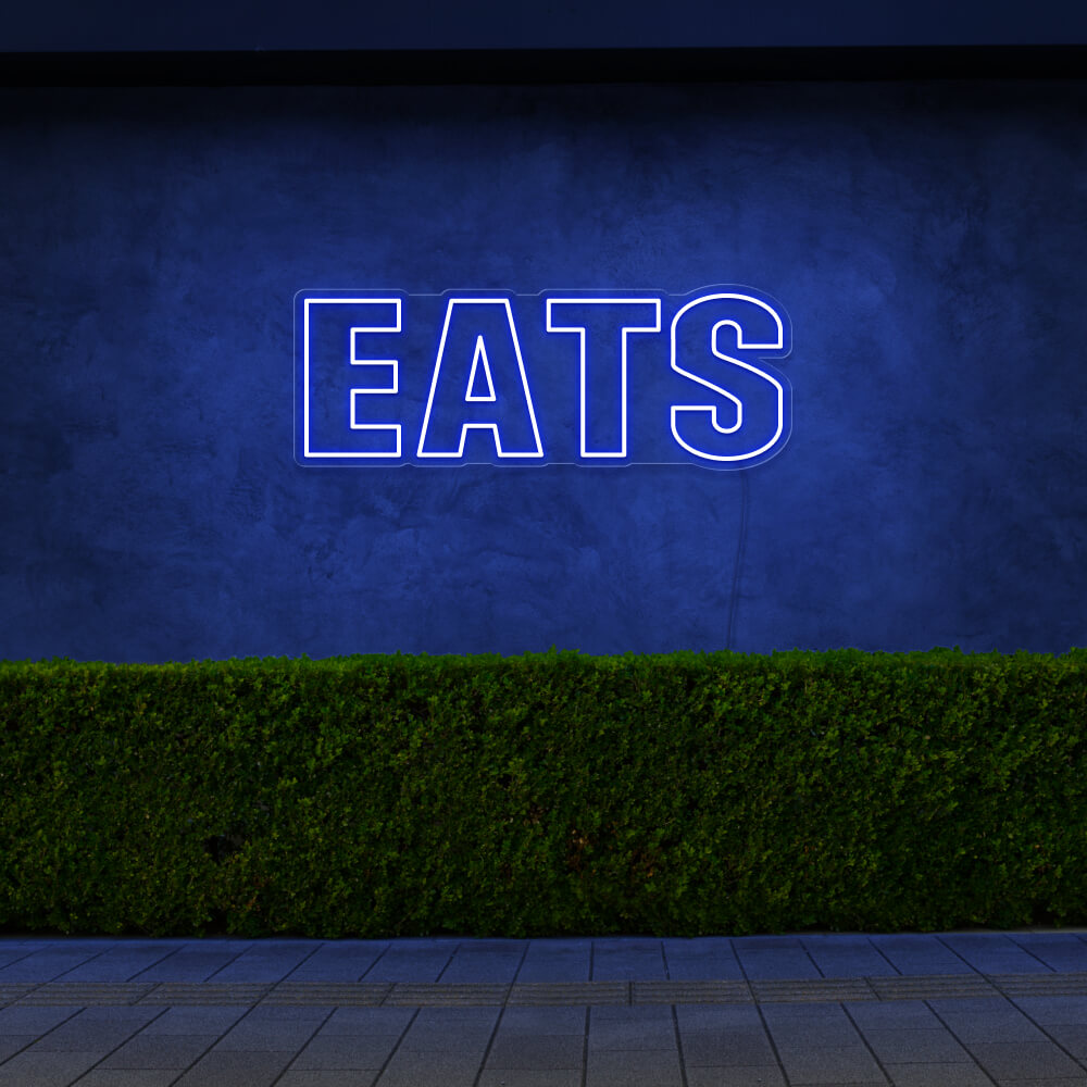 blue eats neon sign hanging on outside wall