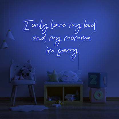 blue I only love my bed and my momma I'm sorry neon sign hanging on kids wall