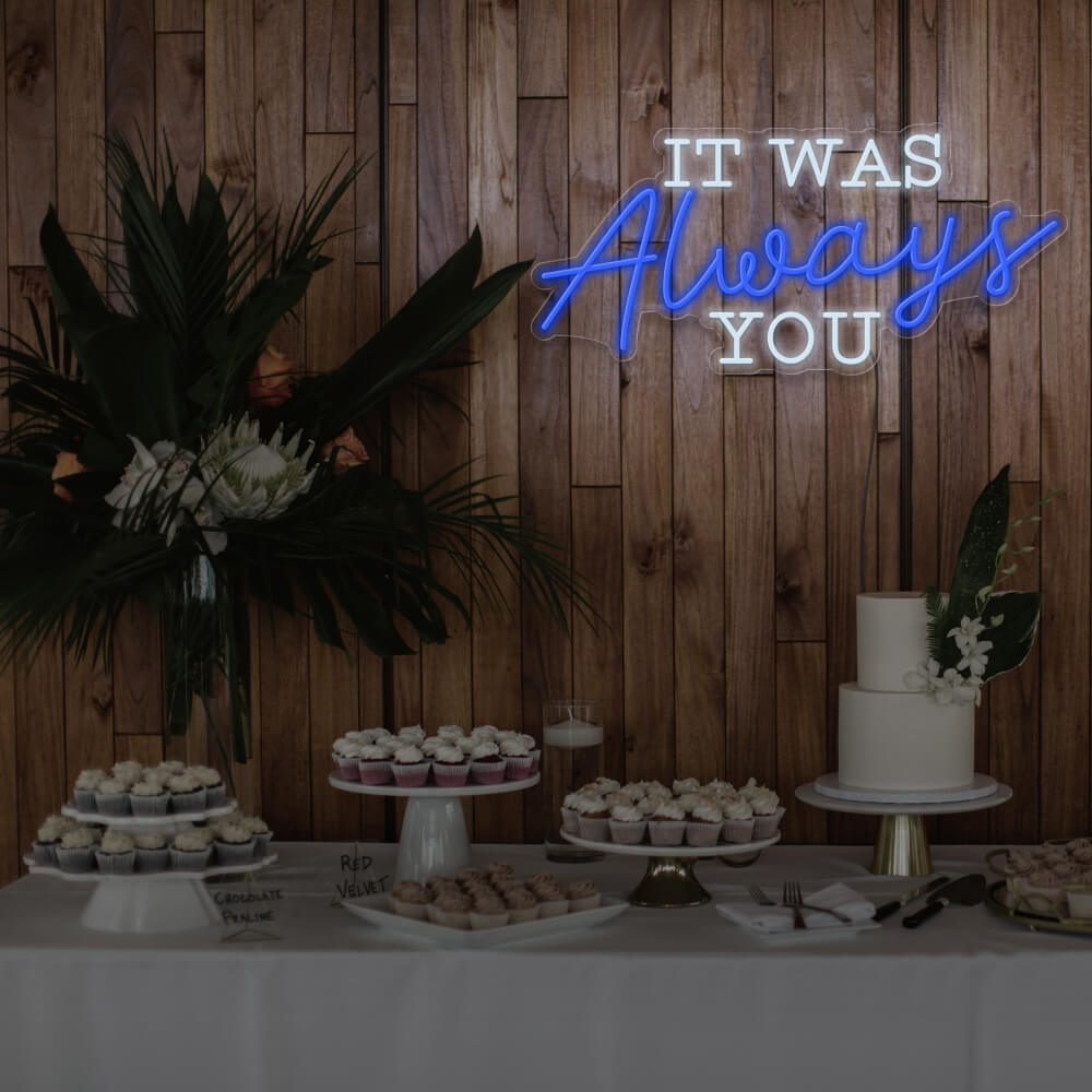 blue it was always you neon sign hanging above dessert table