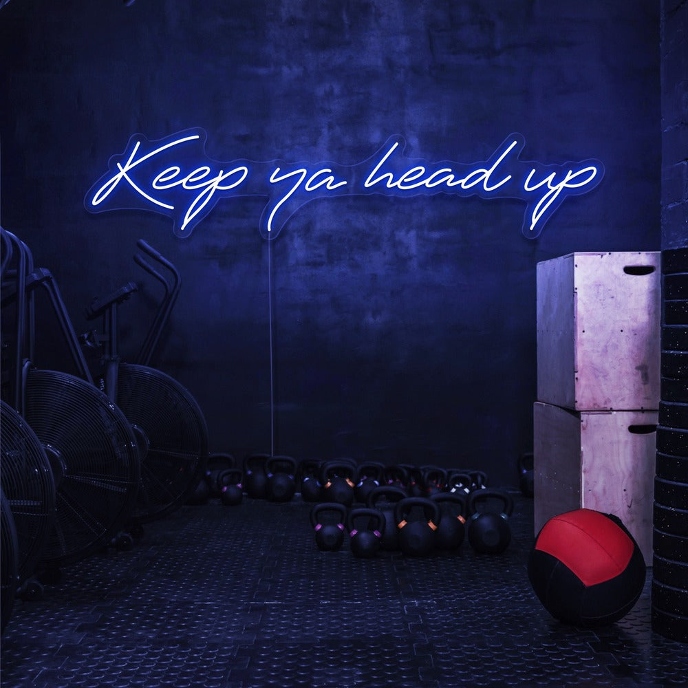 blue keep ya head up neon sign hanging on gym wall