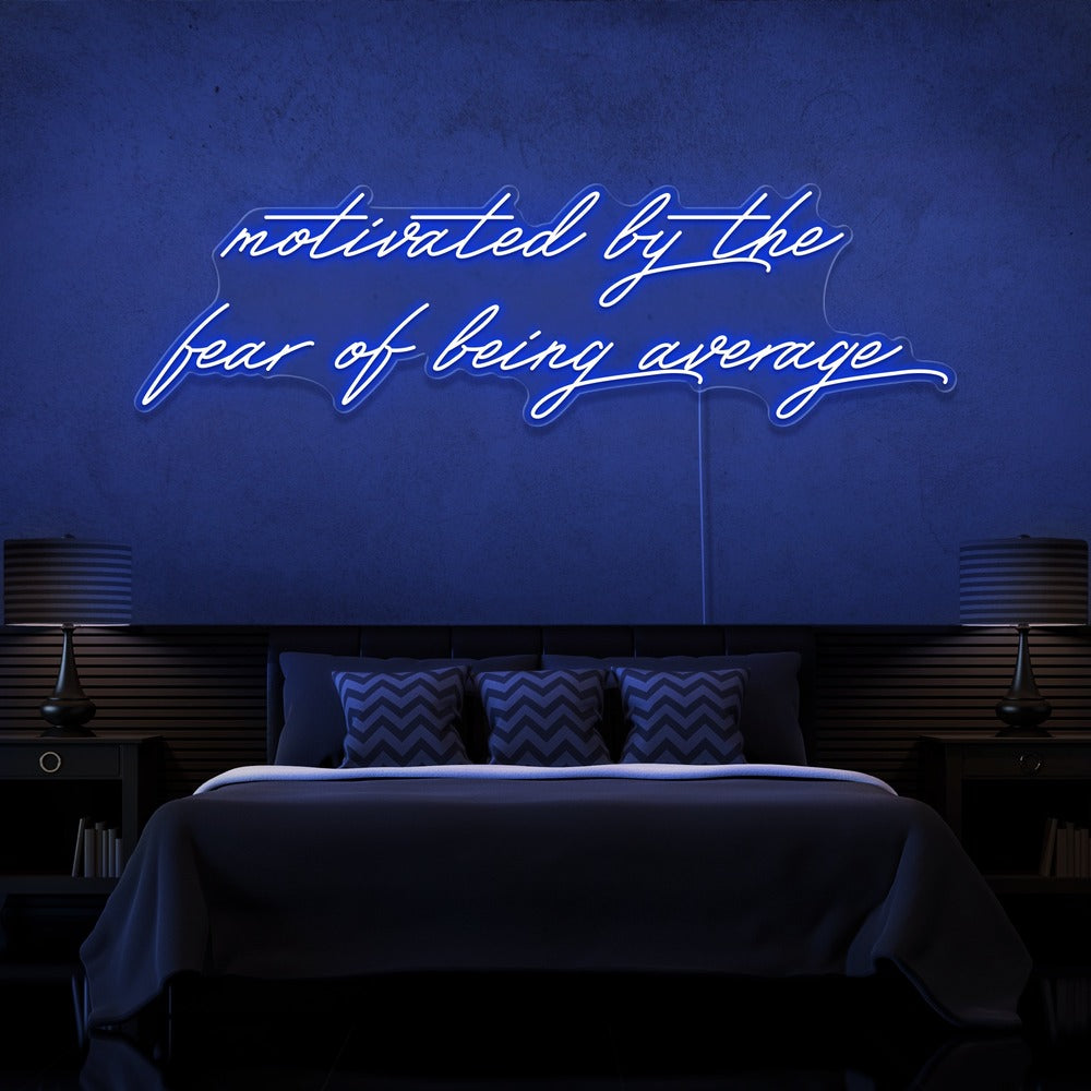 blue motivated by the fear of being average neon sign hanging on bedroom wall