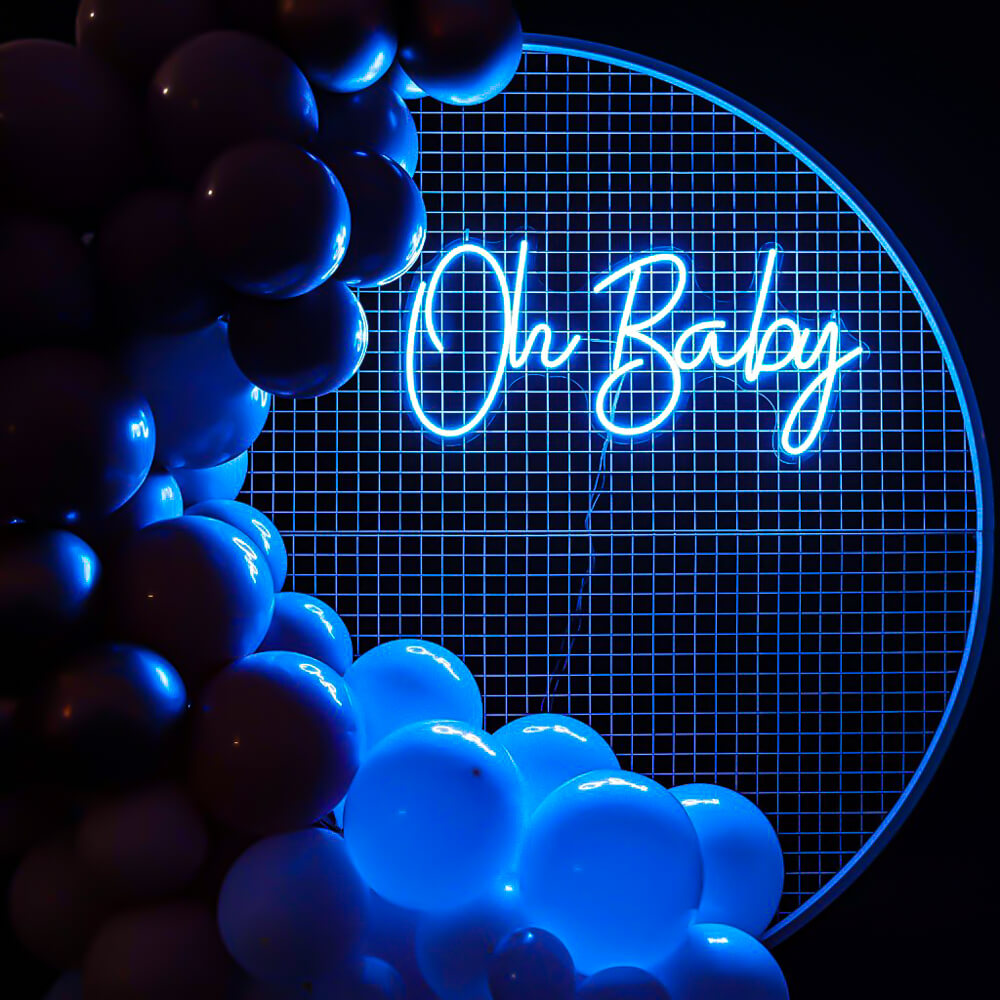 blue oh baby neon sign hanging on white mesh backdrop frame with balloons