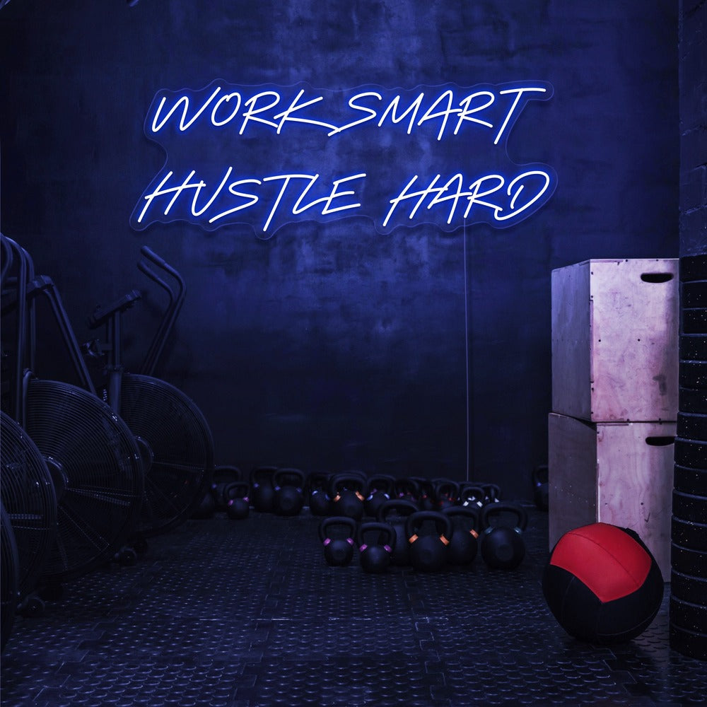 blue work smart hustle hard neon sign hanging on gym wall