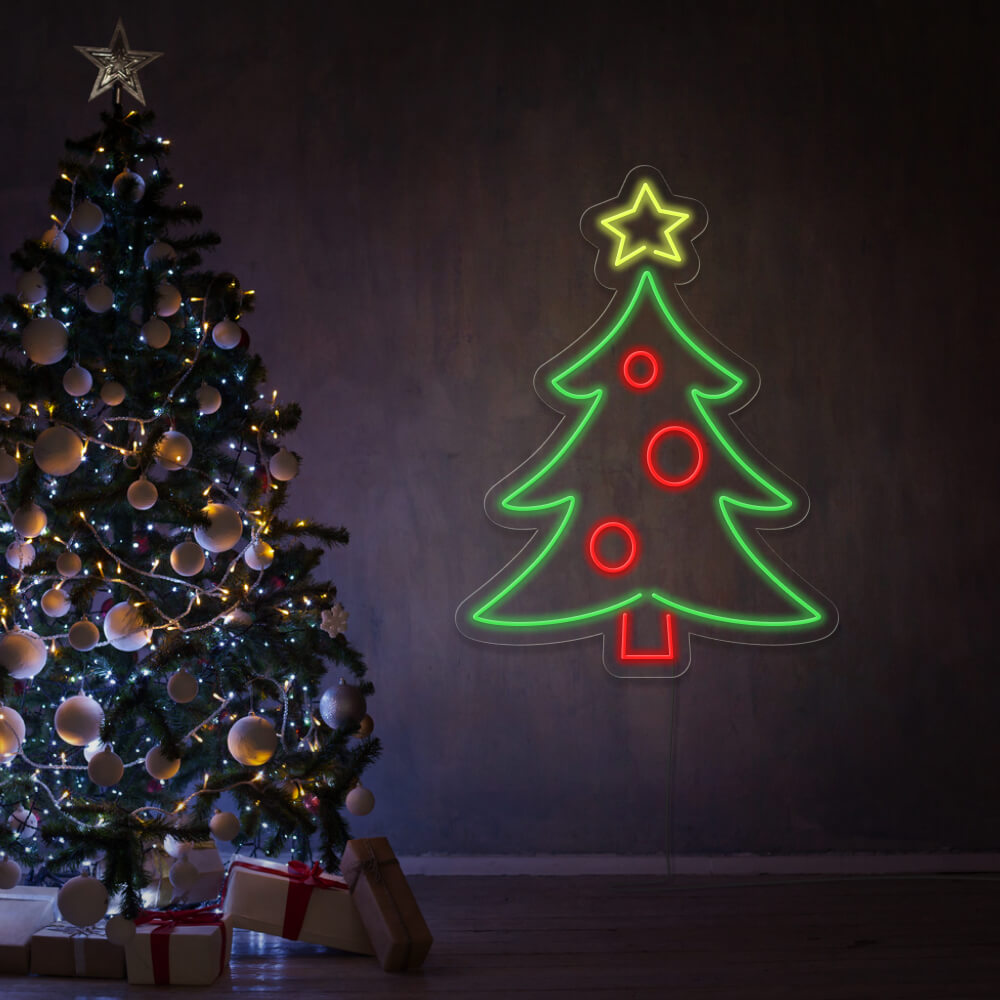 Christmas tree neon sign hanging on wall next to Christmas tree