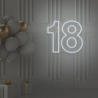 cold white 18 neon sign hanging on wall with balloons