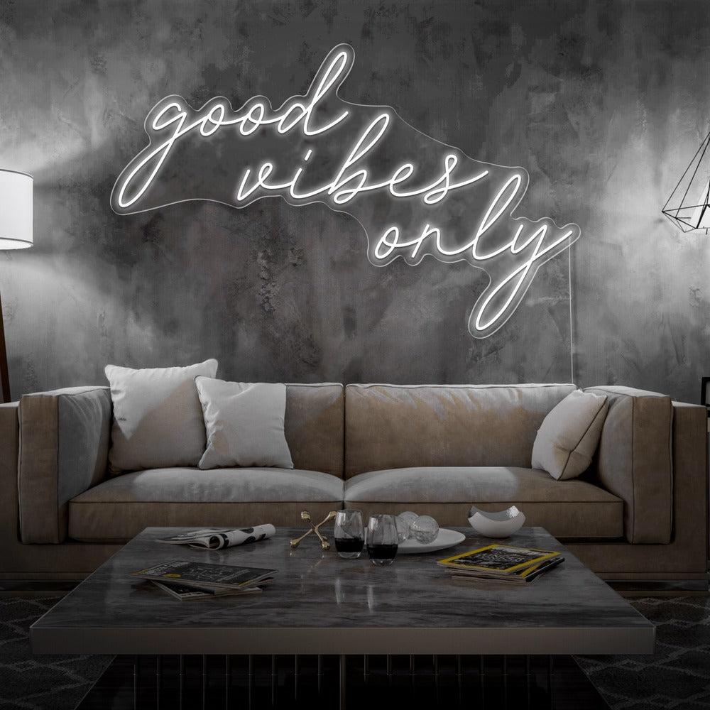 cold white good vibes only neon sign hanging on living room wall