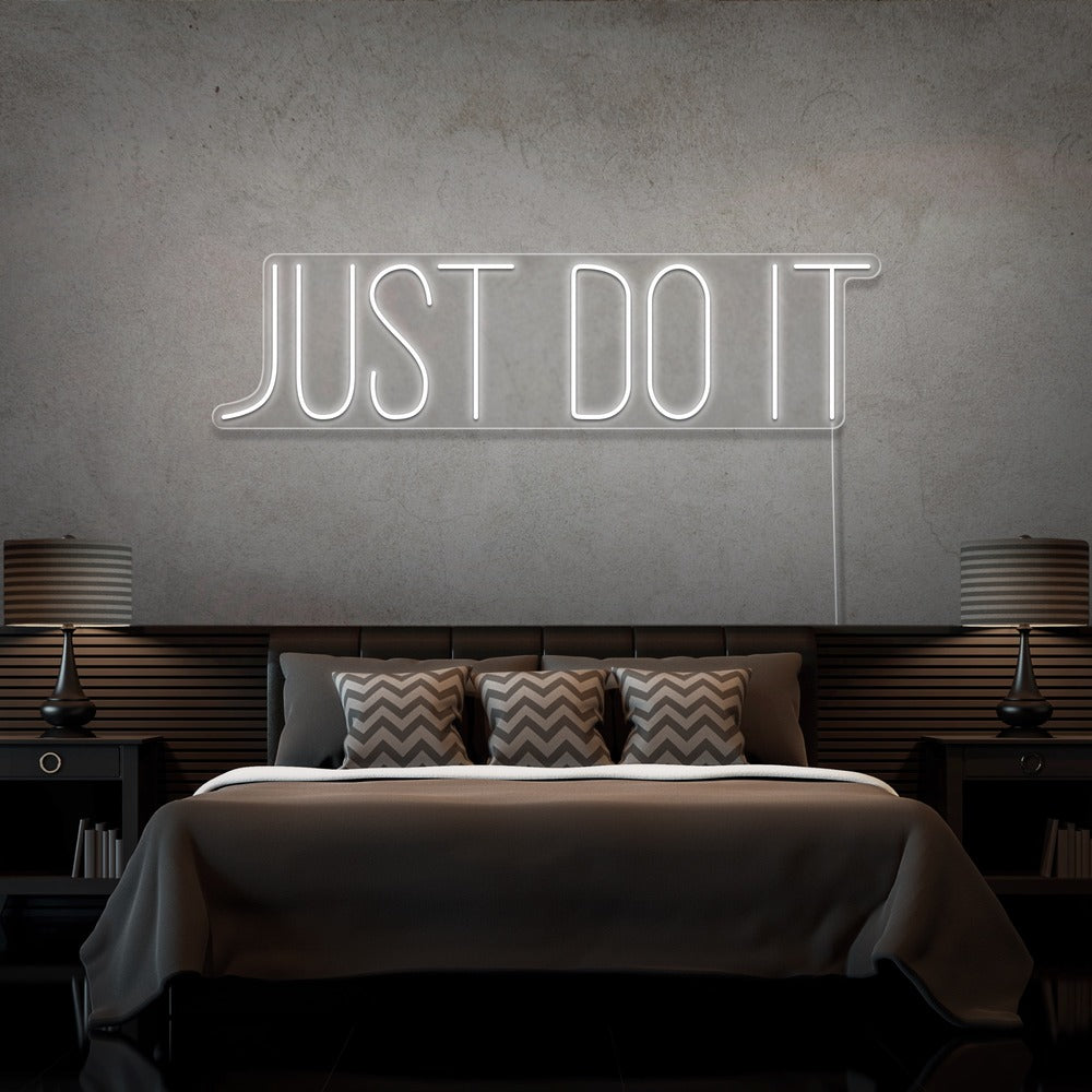 cold white just do it neon sign hanging on bedroom wall