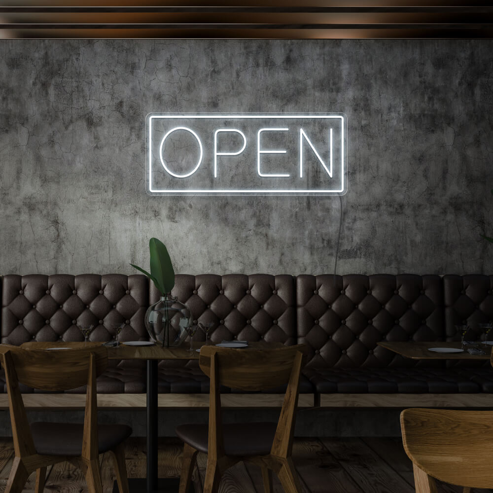 cold white open neon sign hanging on cafe wall