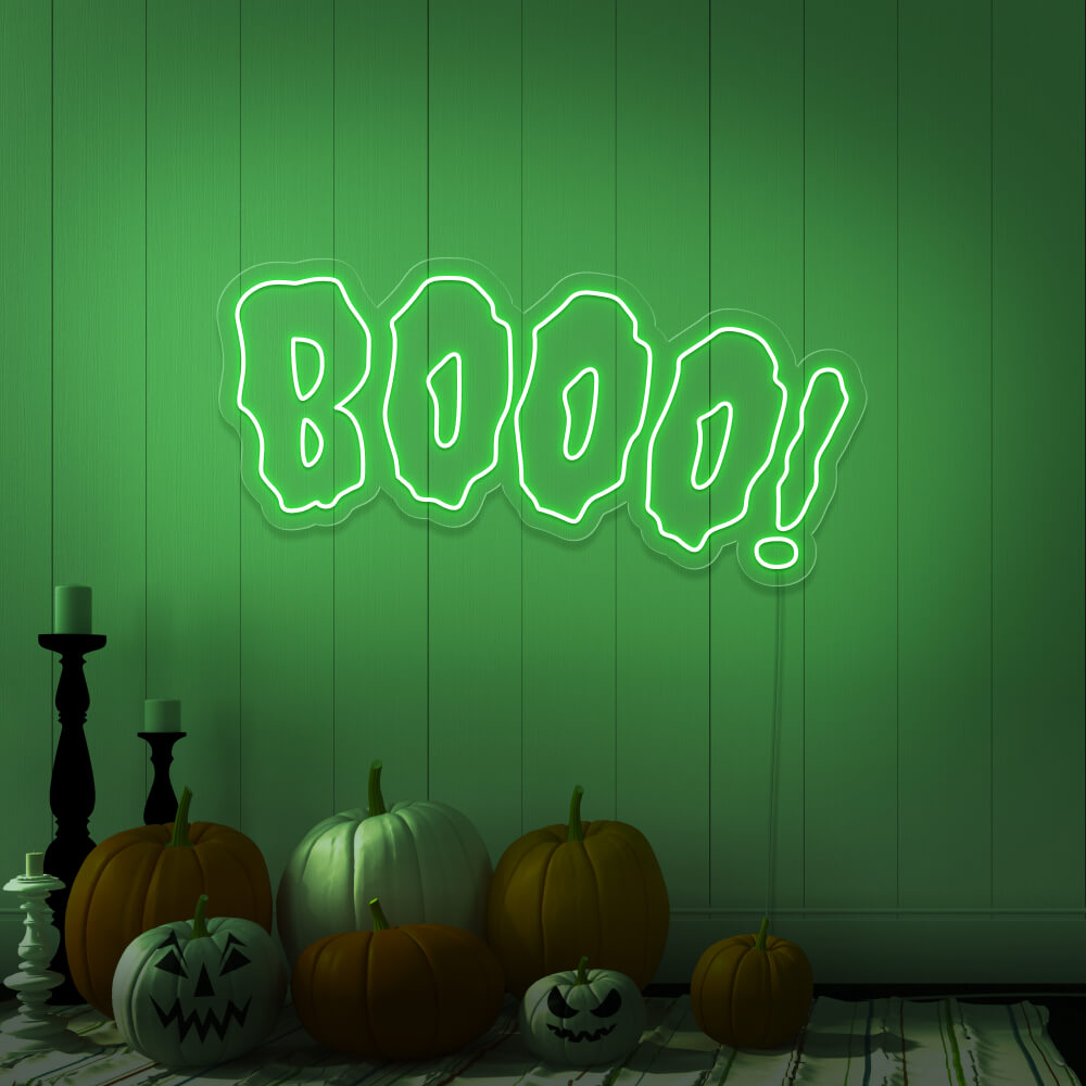 green boo neon sign with halloween pumpkins on floor