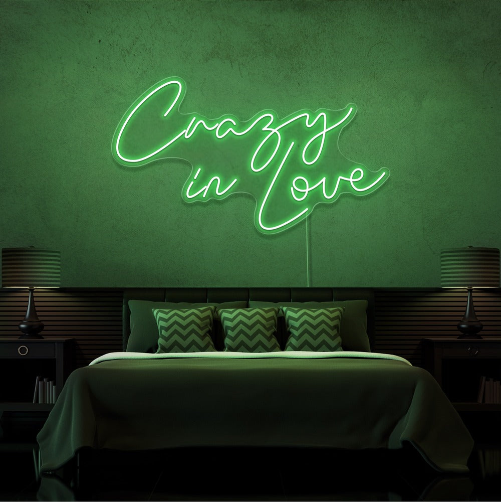 green crazy in love neon sign hanging on bedroom wall