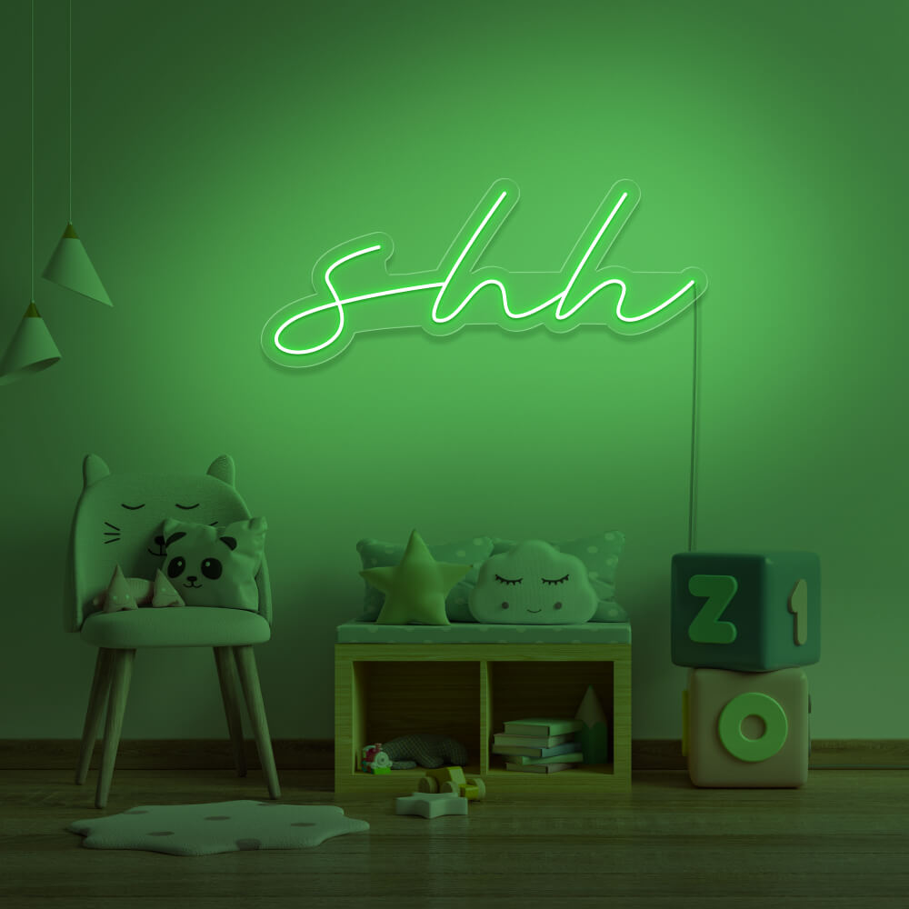 green shh neon sign hanging on kids bedroom wall