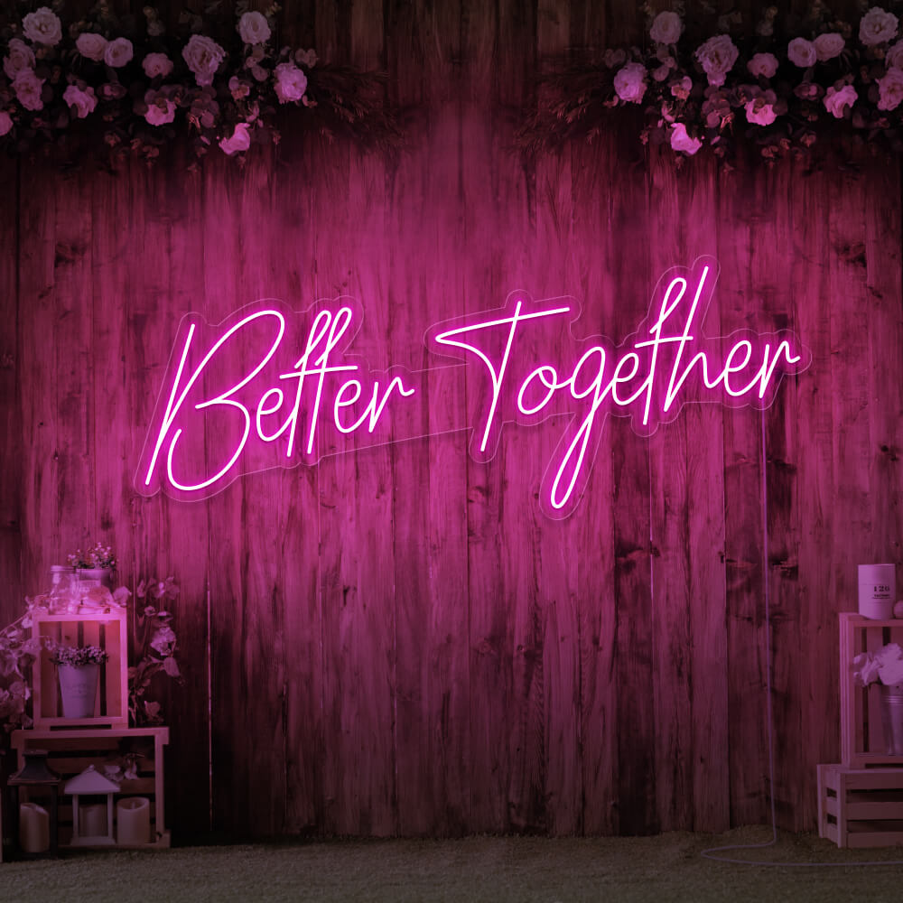 hot pink better together neon sign hanging on timber wall