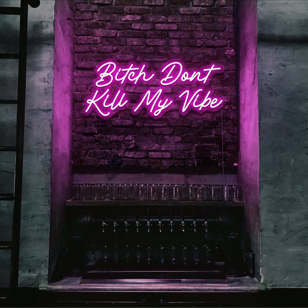 hot pink bitch don't kill my vibe neon sign hanging on bar wall