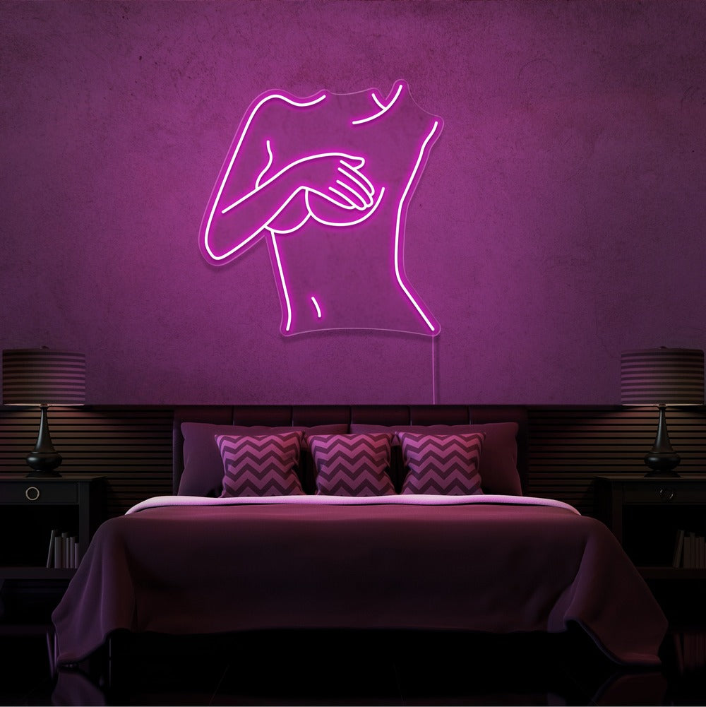 hot pink cover up neon sign hanging on bedroom wall