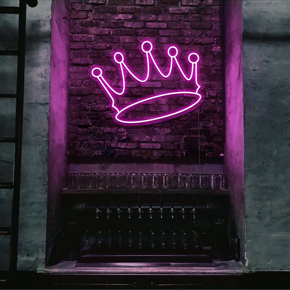 hot pink crown neon sign hanging on bar wall