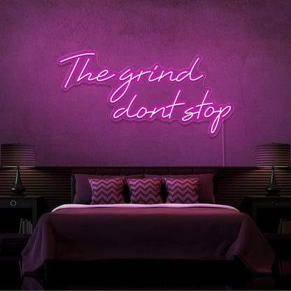 hot pink the grind dont stop neon sign hanging on bedroom wall