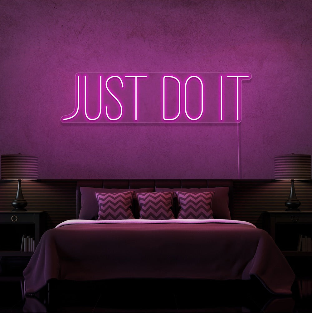 hot pink just do it neon sign hanging on bedroom wall