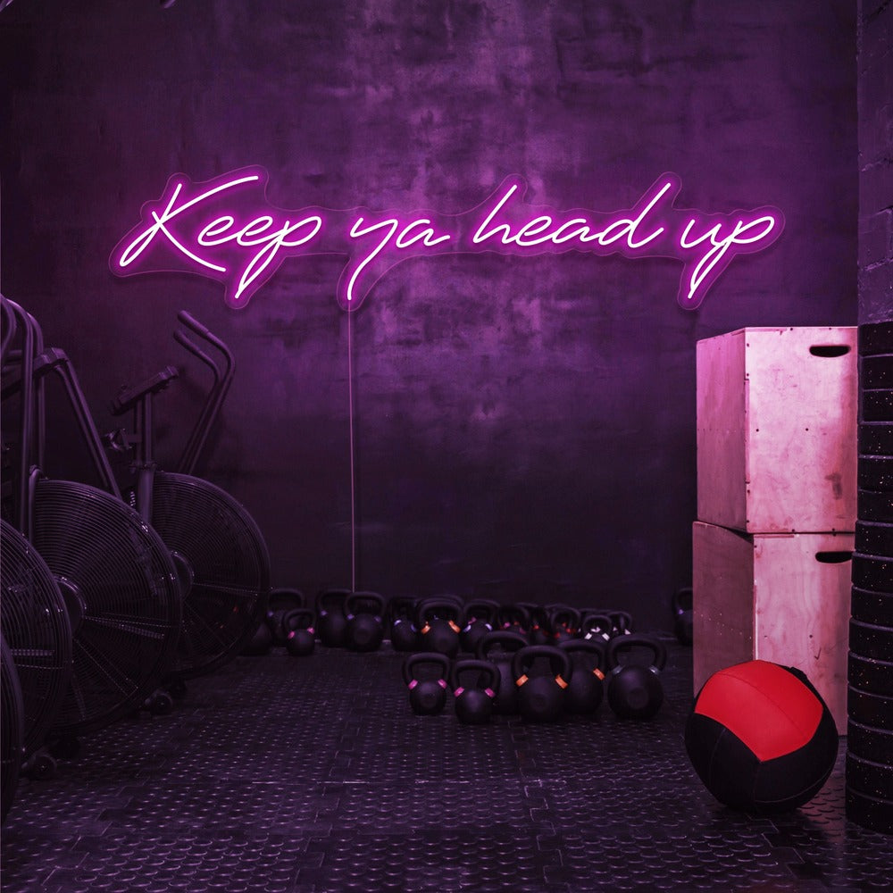 hot pink keep ya head up neon sign hanging on gym wall