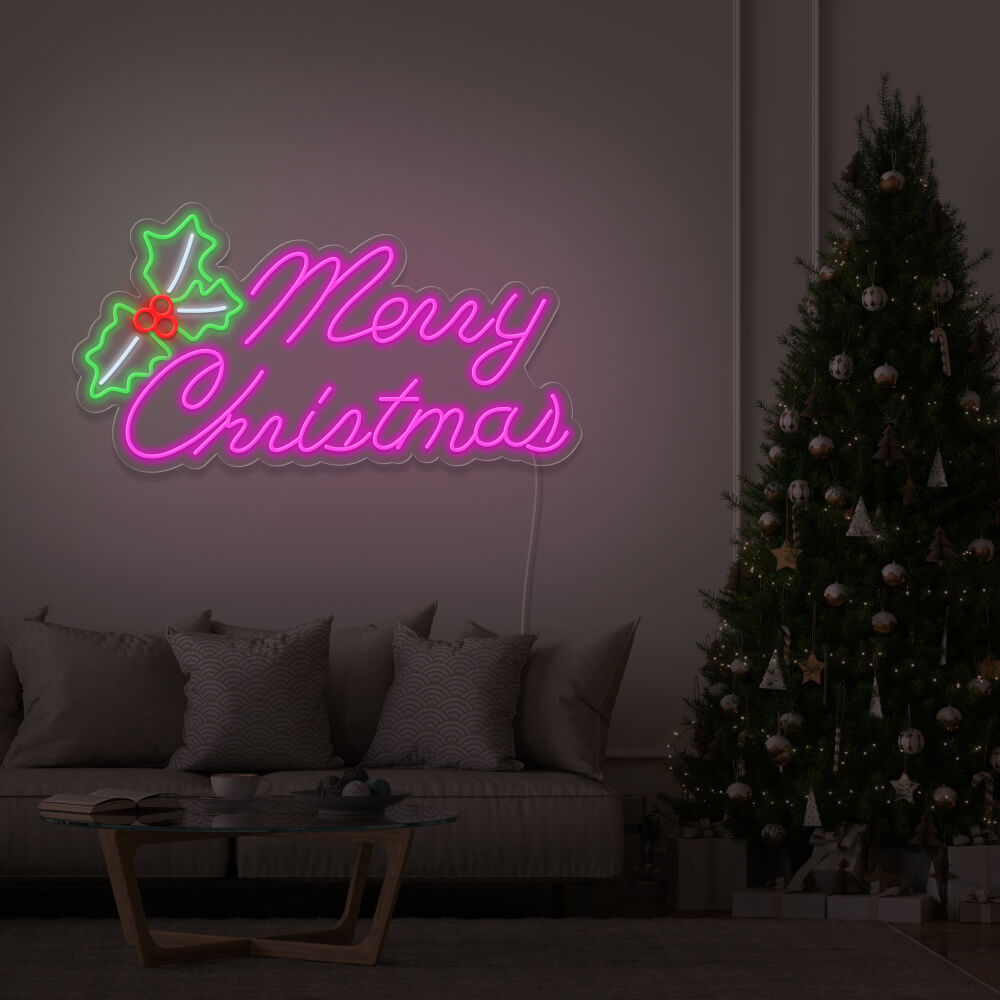 hot pink merry chirstmas mistletoe neon sign hanging above couch next to christmas tree