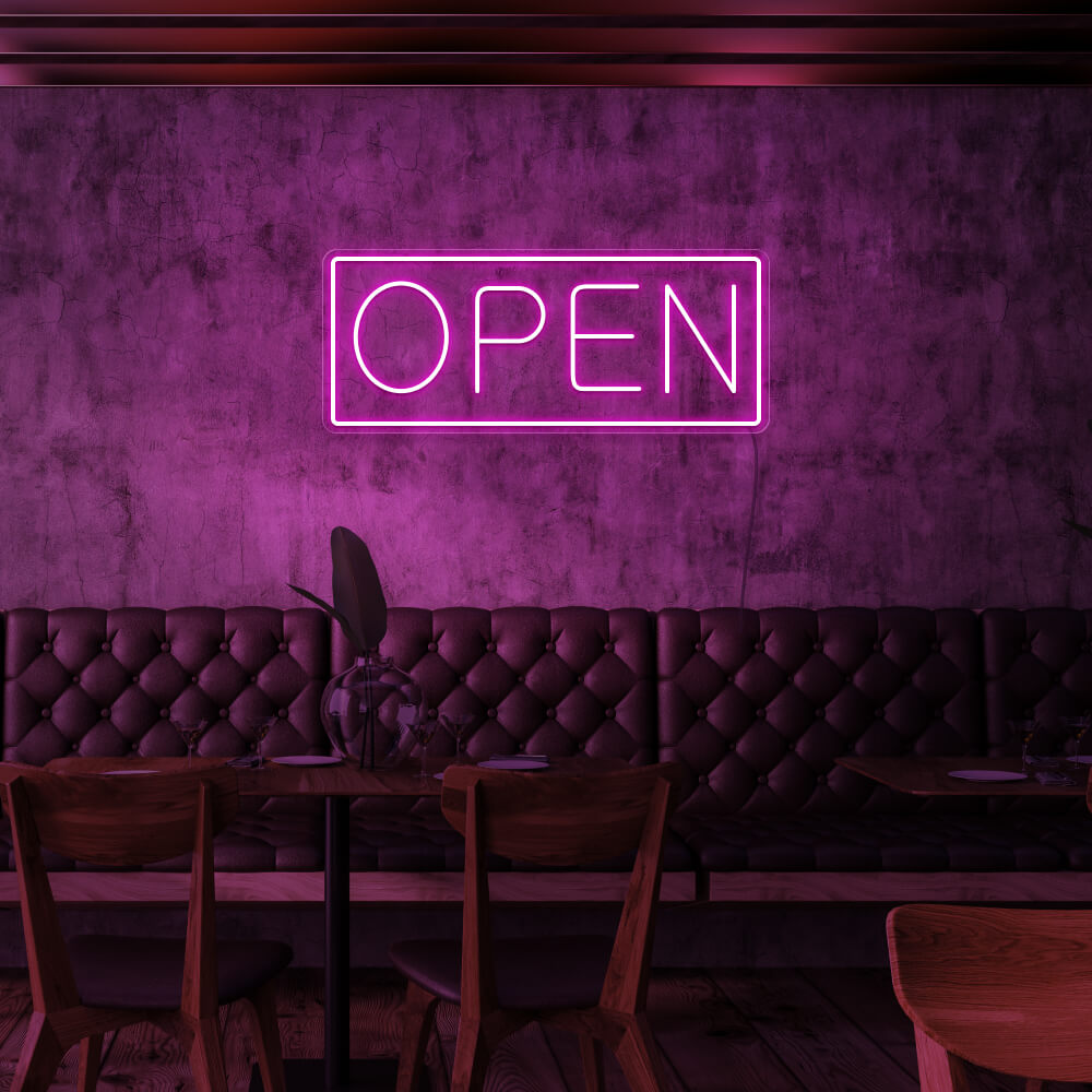 hot pink open neon sign hanging on cafe wall