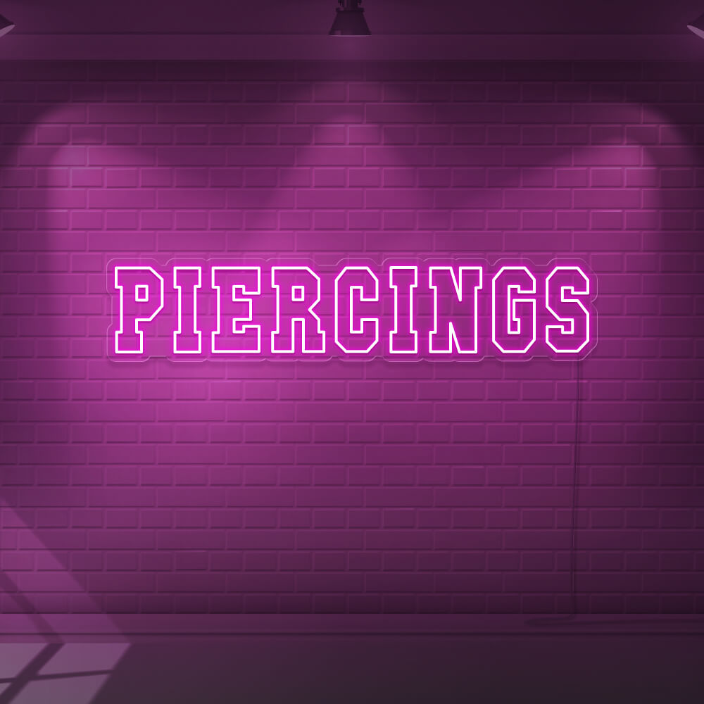 hot pink piercings neon sign hanging on wall