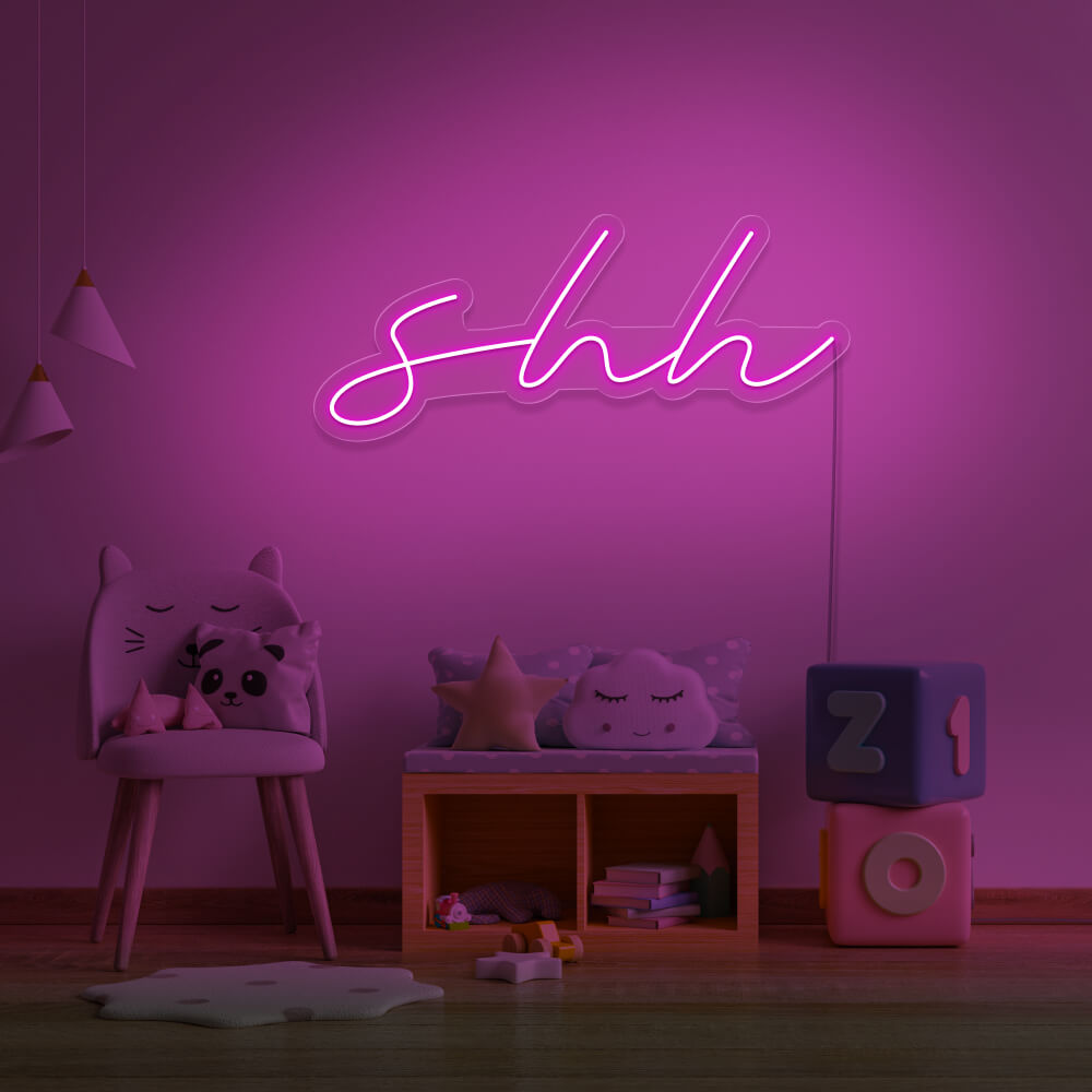 hot pink shh neon sign hanging on kids bedroom wall