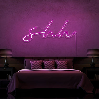 hot pink shh neon sign hanging on bedroom wall