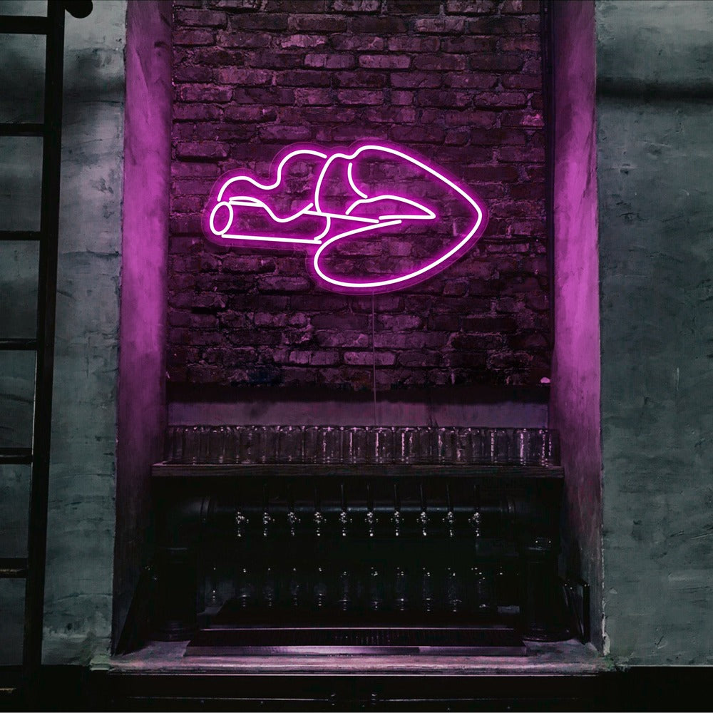 hot pink smoking lips neon sign hanging on bar wall