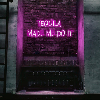 hot pink tequila made me do it neon sign hanging on bar wall