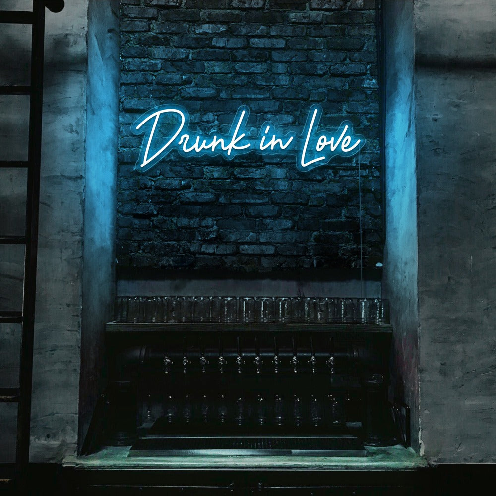 ice blue drunk in love neon sign hanging on bar wall