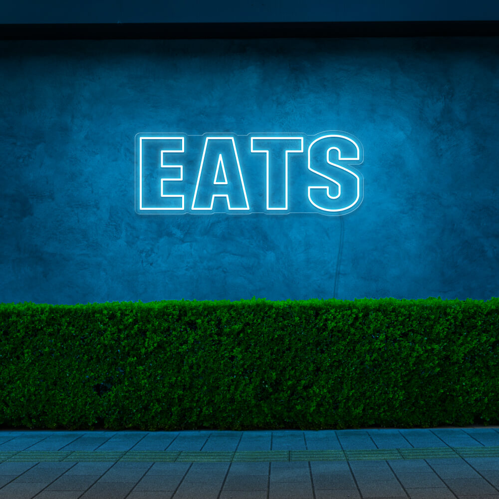 ice blue eats neon sign hanging on outside wall