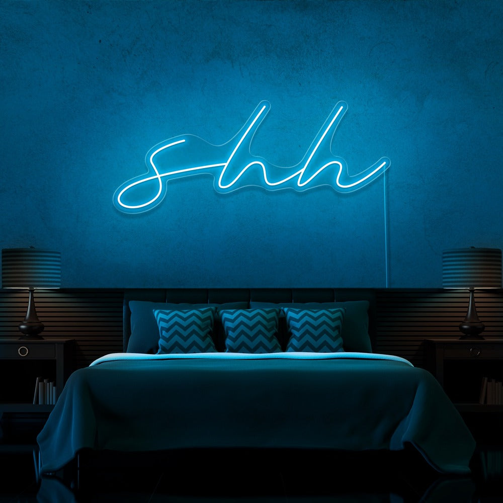 ice blue shh neon sign hanging on bedroom wall