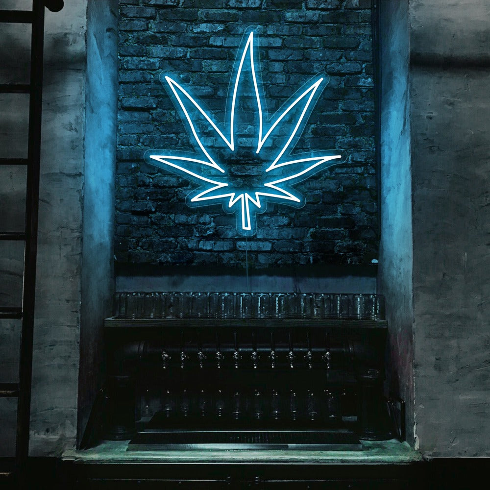 ice blue weed leaf neon sign hanging on bar wall