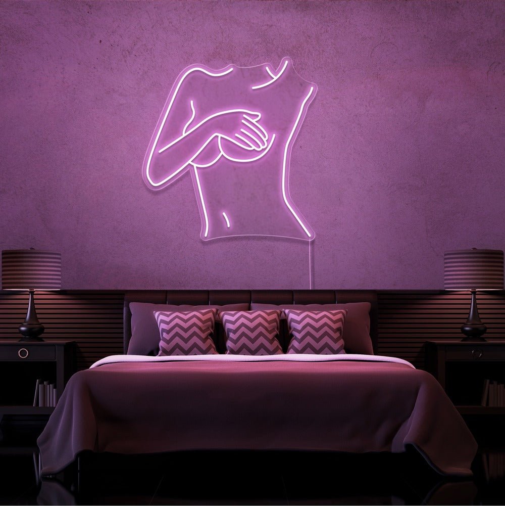 light pink cover up neon sign hanging on bedroom wall