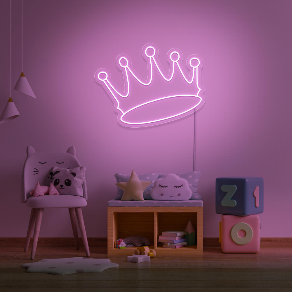 light pink crown neon sign hanging on kids bedroom wall