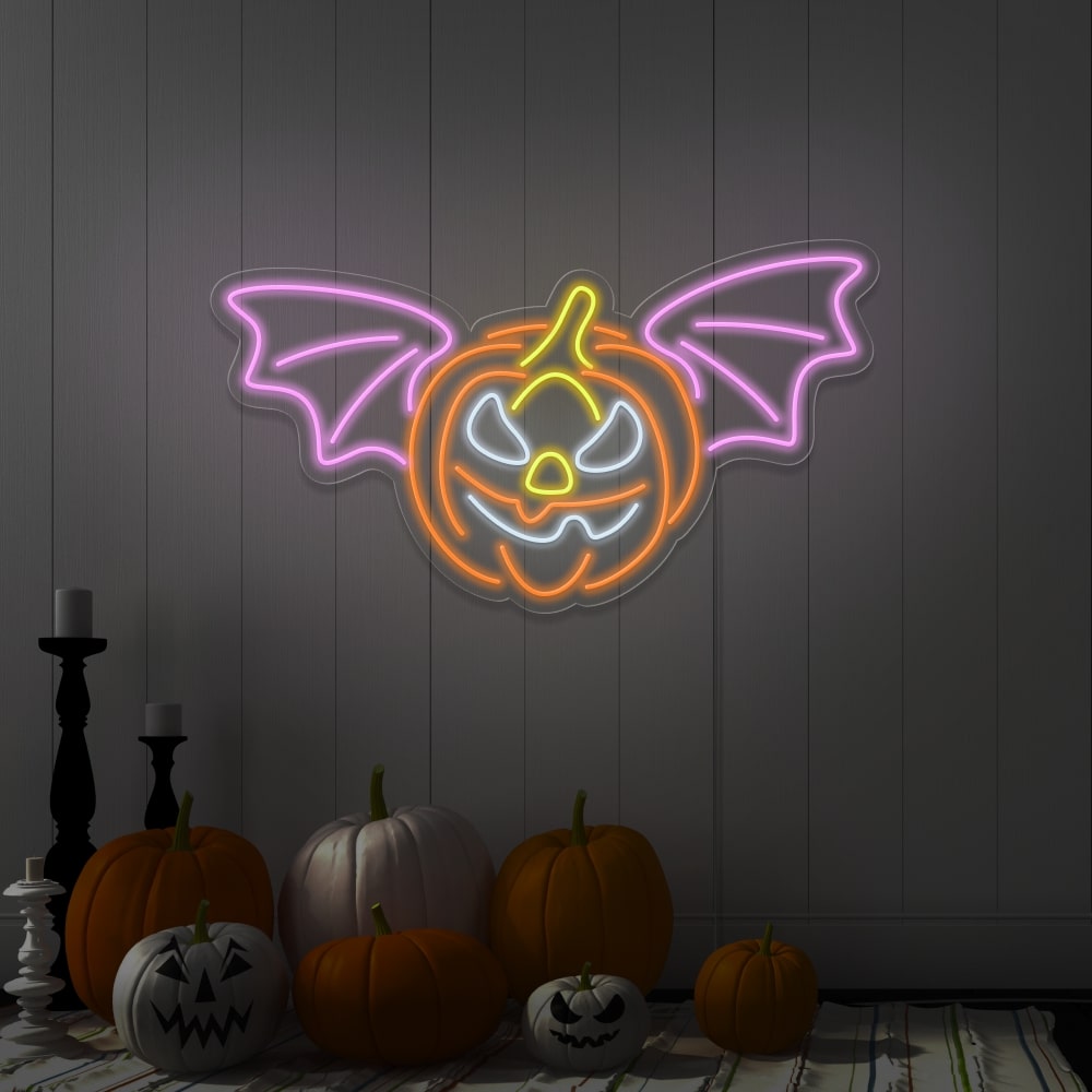 light pink flying pumpkin neon sign hanging on wall above pumpkins