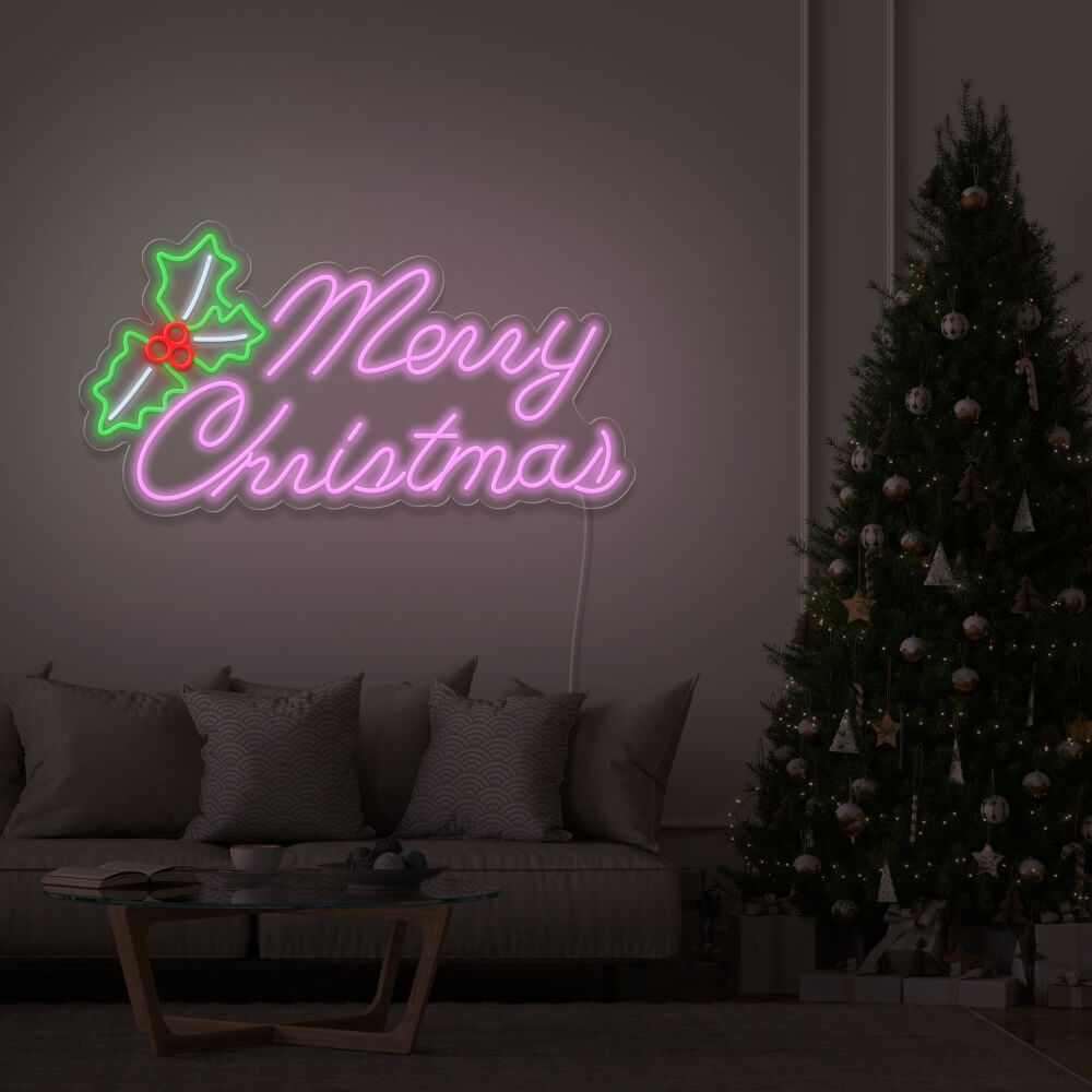 light pink merry chirstmas mistletoe neon sign hanging above couch next to christmas tree