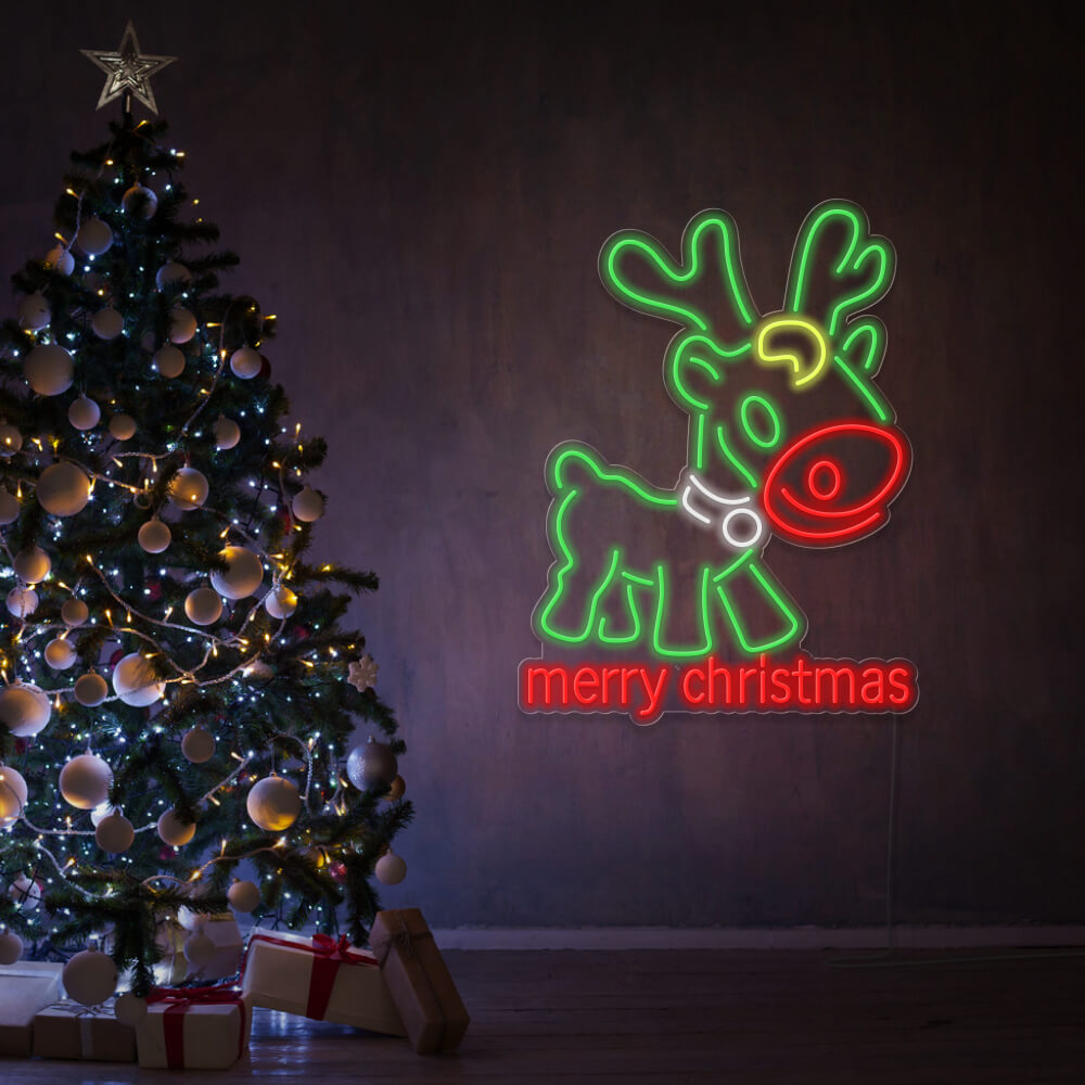multicoloured merry christmas rudolph neon sign hanging on wall next christmas tree