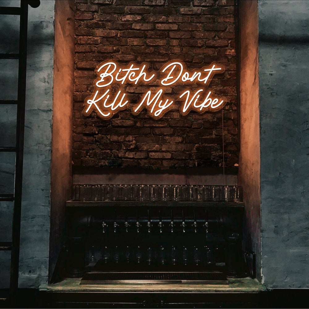 orange bitch don't kill my vibe neon sign hanging on bar wall