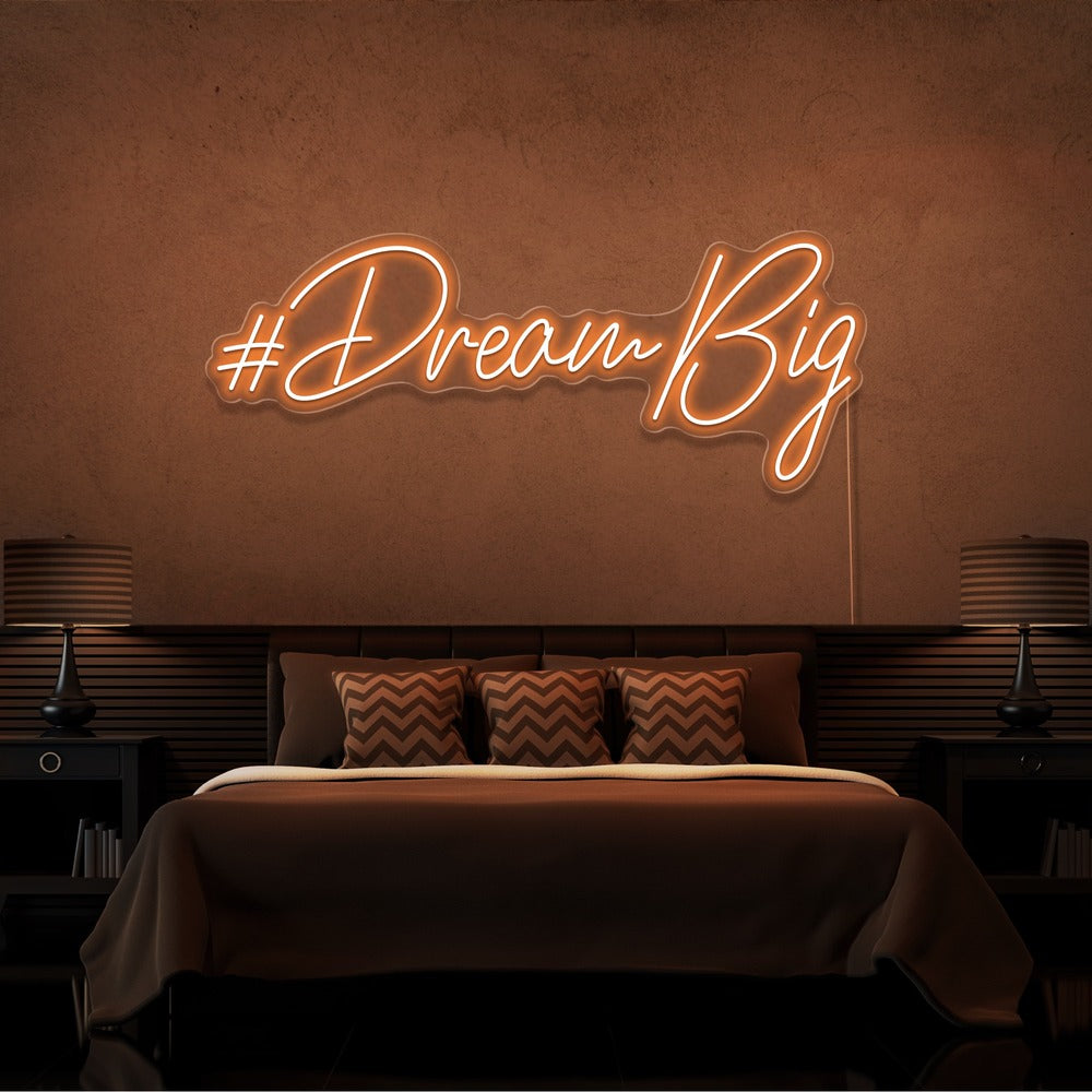 orange dream big neon sign hanging on bedroom wall